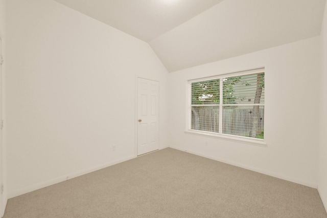 3722 Lovers Ln, Montgomery, TX 77356 - spare room with light carpet, baseboards, and lofted ceiling