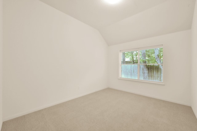 3722 Lovers Ln, Montgomery, TX 77356 - unfurnished room featuring light colored carpet, lofted ceiling, and baseboards