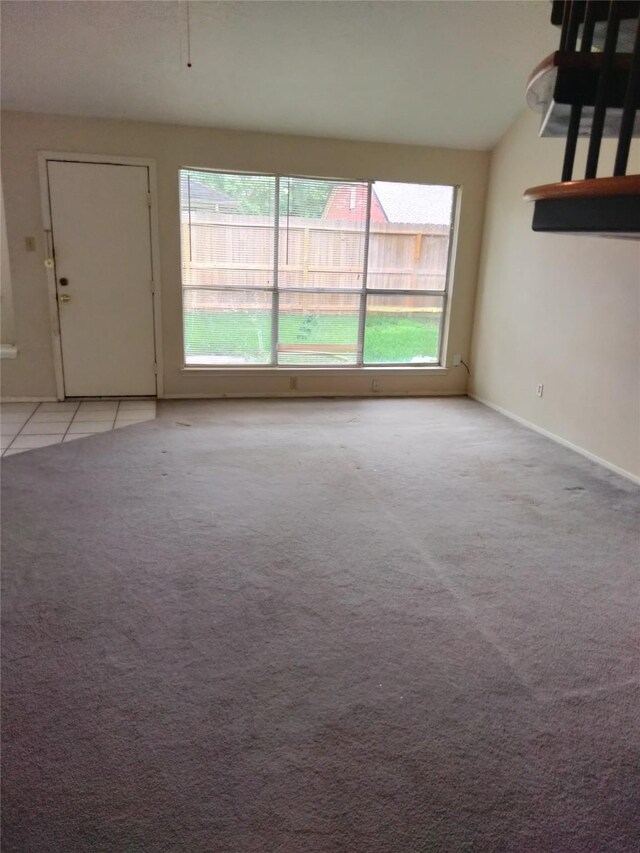 carpeted empty room with baseboards
