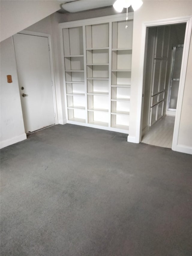 unfurnished bedroom featuring baseboards and carpet flooring