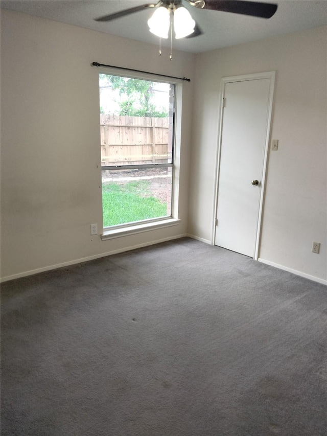 spare room featuring a ceiling fan, carpet floors, and baseboards