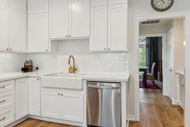 15411 Parkwood Way, Houston, TX 77059 - kitchen featuring dishwasher, a sink, light countertops, tasteful backsplash, and light wood finished floors