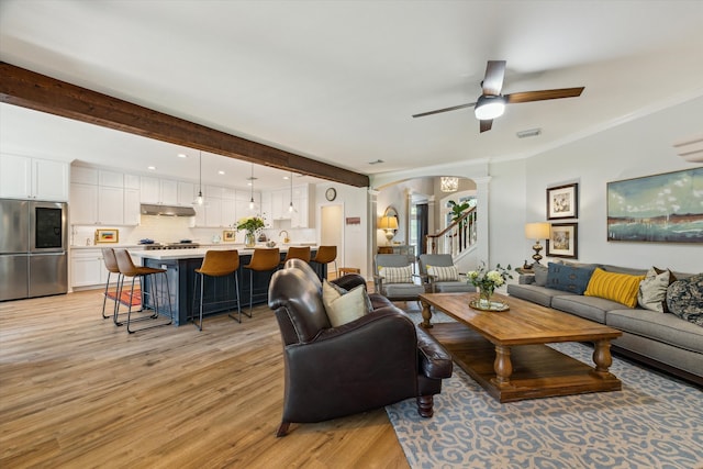 15411 Parkwood Way, Houston, TX 77059 - living area featuring ornate columns, light wood-type flooring, a ceiling fan, arched walkways, and crown molding