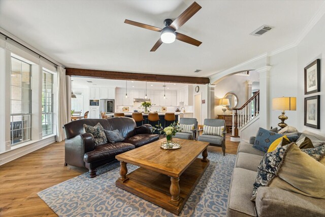 15411 Parkwood Way, Houston, TX 77059 - living room with ceiling fan, arched walkways, light wood-style floors, ornamental molding, and stairs