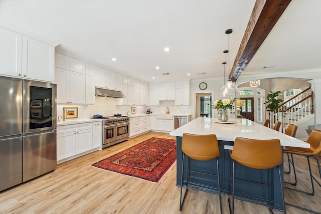 15411 Parkwood Way, Houston, TX 77059 - kitchen featuring appliances with stainless steel finishes, under cabinet range hood, light wood-style flooring, a sink, and crown molding