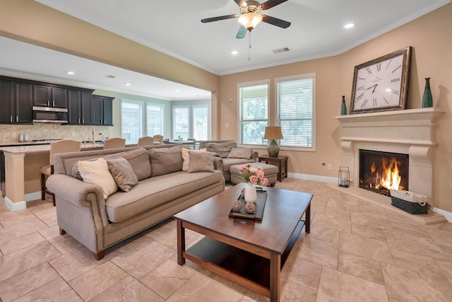 510 Pearl View Ln, Pinehurst, TX 77362 - living room featuring ceiling fan, crown molding, recessed lighting, baseboards, and a warm lit fireplace