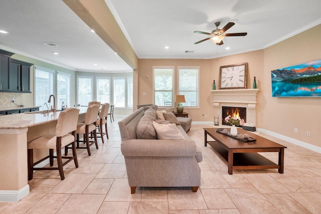 510 Pearl View Ln, Pinehurst, TX 77362 - living room featuring ornamental molding, plenty of natural light, recessed lighting, a warm lit fireplace, and a ceiling fan