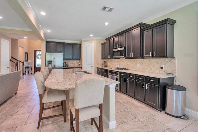 510 Pearl View Ln, Pinehurst, TX 77362 - kitchen featuring a sink, appliances with stainless steel finishes, crown molding, light stone counters, and backsplash