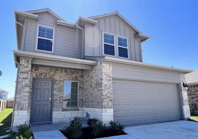 21310 Black Leaf Dr, New Caney, TX 77357 - view of front of home featuring a garage, driveway, board and batten siding, and stone siding