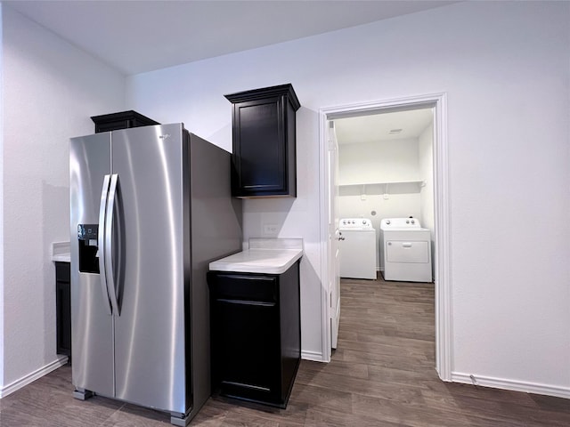 21310 Black Leaf Dr, New Caney, TX 77357 - kitchen with stainless steel fridge, washer and clothes dryer, light countertops, dark wood-style floors, and baseboards