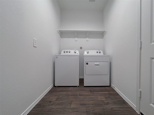 21310 Black Leaf Dr, New Caney, TX 77357 - clothes washing area with washer and clothes dryer, dark wood-style flooring, and baseboards