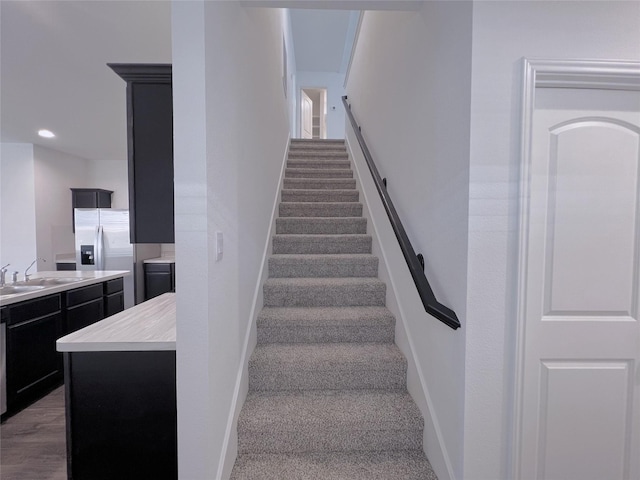 21310 Black Leaf Dr, New Caney, TX 77357 - staircase with baseboards, carpet, and recessed lighting