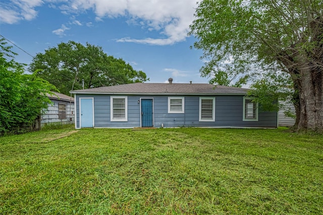 rear view of house with a yard