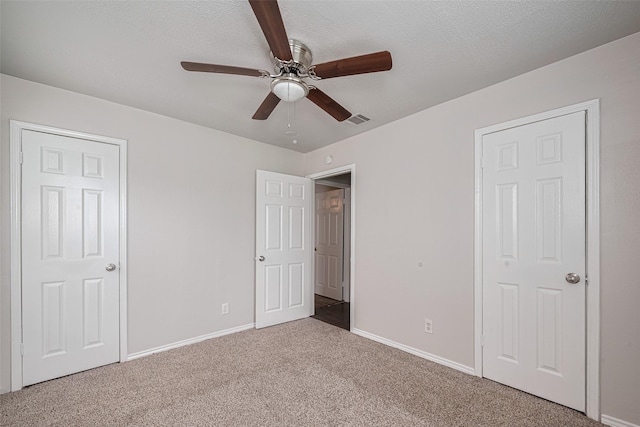 unfurnished bedroom with carpet floors, baseboards, and a ceiling fan