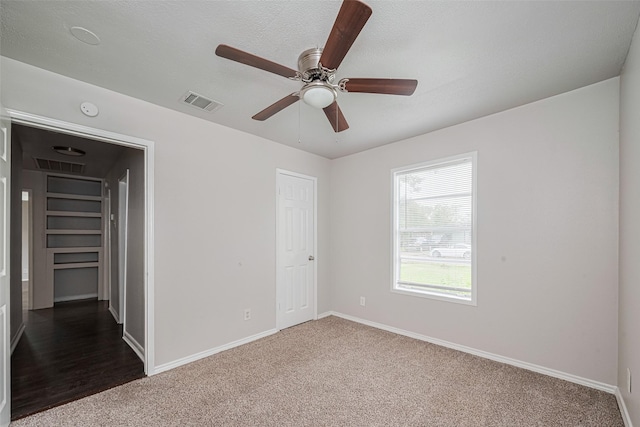 unfurnished bedroom featuring carpet flooring, baseboards, ceiling fan, and a closet