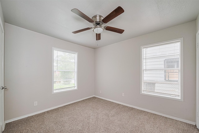 unfurnished room with carpet, baseboards, and a ceiling fan