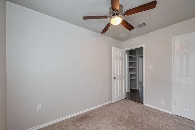unfurnished bedroom with carpet, baseboards, and a ceiling fan