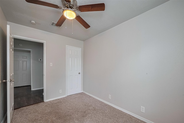 unfurnished bedroom featuring carpet flooring, baseboards, and a ceiling fan