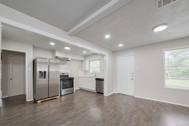 kitchen with stainless steel appliances, a sink, dark wood-style floors, white cabinetry, and recessed lighting