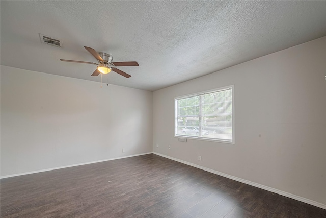 empty room with ceiling fan, dark wood-style floors, baseboards, and a textured ceiling
