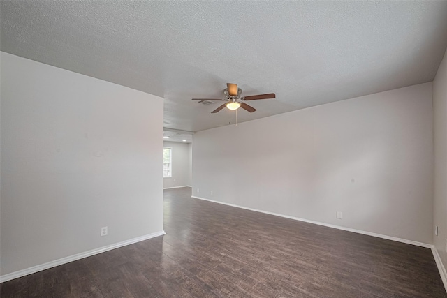 empty room featuring ceiling fan, dark wood-type flooring, and baseboards