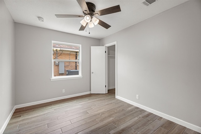 unfurnished bedroom with wood finished floors and baseboards