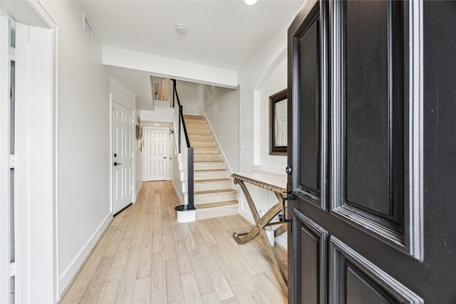 822 Reinicke St, Houston, TX 77007 - entrance foyer with light wood-style flooring, stairway, and baseboards