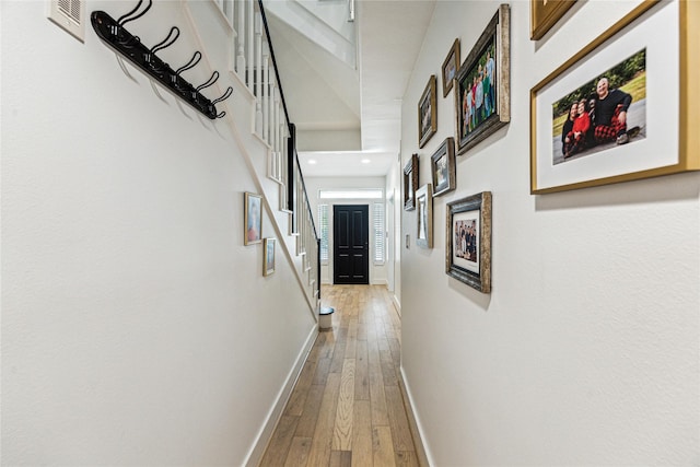 822 Reinicke St, Houston, TX 77007 - hallway with baseboards, light wood-style flooring, stairs, and recessed lighting