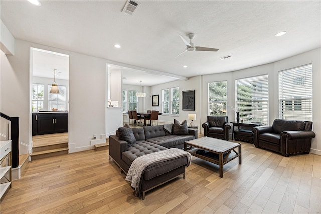 822 Reinicke St, Houston, TX 77007 - living room featuring light wood finished floors, recessed lighting, healthy amount of natural light, a ceiling fan, and baseboards