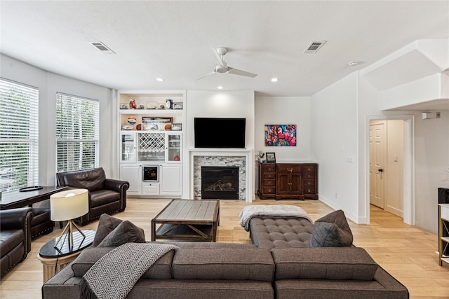 822 Reinicke St, Houston, TX 77007 - living area featuring light wood-style floors, a ceiling fan, a glass covered fireplace, and recessed lighting