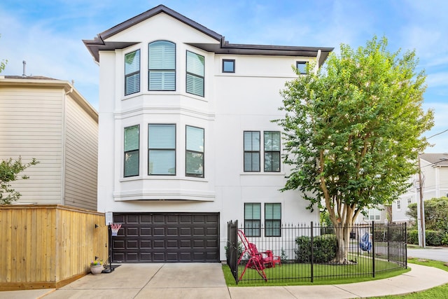 822 Reinicke St, Houston, TX 77007 - view of front of house with stucco siding, a garage, driveway, and fence