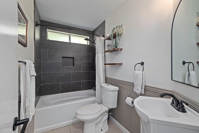 13 Leverwood Ct, The Woodlands, TX 77381 - full bathroom with a sink, tile patterned floors, toilet, shower / tub combo with curtain, and a wainscoted wall