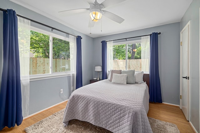 13 Leverwood Ct, The Woodlands, TX 77381 - bedroom with wood finished floors, baseboards, and ceiling fan