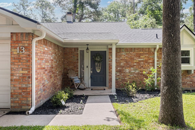 13 Leverwood Ct, The Woodlands, TX 77381 - entrance to property featuring brick siding, a shingled roof, a chimney, and a garage