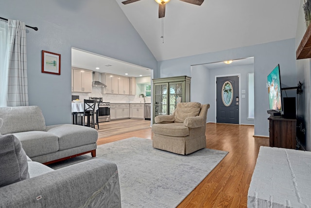 13 Leverwood Ct, The Woodlands, TX 77381 - living area with light wood-style floors, a ceiling fan, and high vaulted ceiling