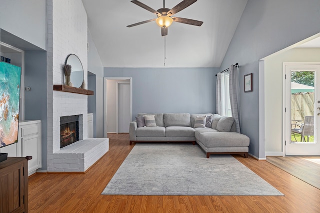 13 Leverwood Ct, The Woodlands, TX 77381 - living area featuring high vaulted ceiling, a ceiling fan, wood finished floors, and a fireplace
