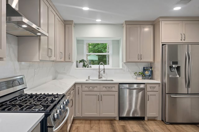 13 Leverwood Ct, The Woodlands, TX 77381 - kitchen with appliances with stainless steel finishes, a sink, wall chimney exhaust hood, tasteful backsplash, and recessed lighting