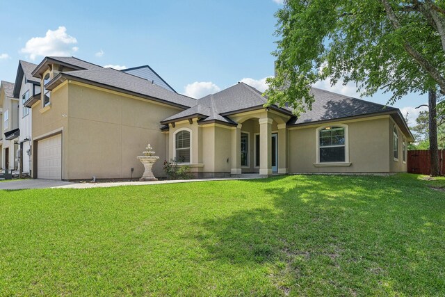 12885 Andromeda Ct, Willis, TX 77318 - view of front facade featuring stucco siding, roof with shingles, and concrete driveway
