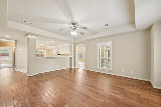 12885 Andromeda Ct, Willis, TX 77318 - unfurnished living room featuring ceiling fan, healthy amount of natural light, and light wood-type flooring