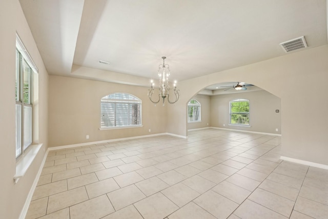 12885 Andromeda Ct, Willis, TX 77318 - unfurnished room with a chandelier, arched walkways, light tile patterned floors, ceiling fan, and baseboards