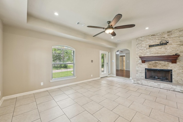 12885 Andromeda Ct, Willis, TX 77318 - unfurnished living room with ceiling fan, arched walkways, a fireplace, recessed lighting, and baseboards