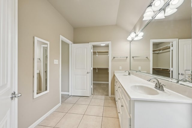 12885 Andromeda Ct, Willis, TX 77318 - bathroom featuring tile patterned floors, baseboards, double vanity, and a walk in closet