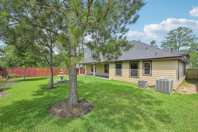 12885 Andromeda Ct, Willis, TX 77318 - rear view of house with central air condition unit and a shingled roof