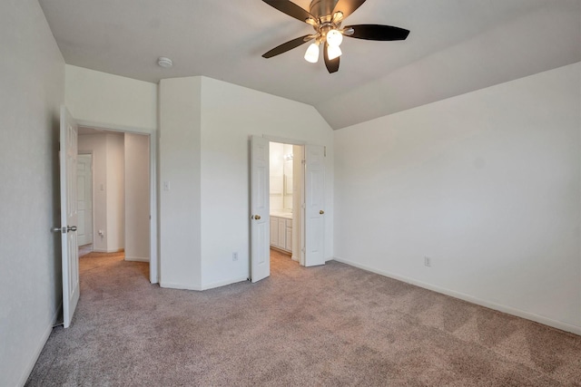 12139 Canyon Arbor Way, Houston, TX 77095 - unfurnished bedroom featuring light carpet, baseboards, vaulted ceiling, connected bathroom, and a ceiling fan