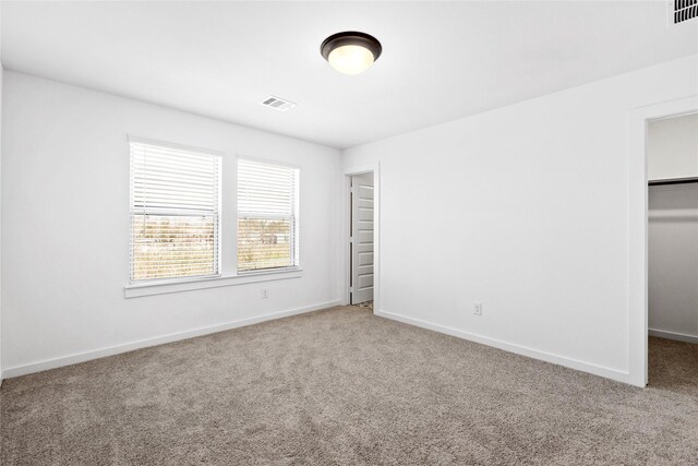 404 Kendall Crest Dr, Alvin, TX 77511 - unfurnished bedroom featuring carpet floors, a spacious closet, baseboards, and a closet