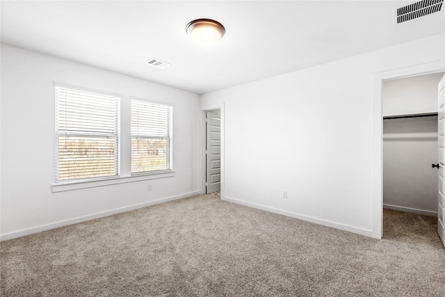 404 Kendall Crest Dr, Alvin, TX 77511 - unfurnished bedroom featuring carpet floors, baseboards, a walk in closet, and a closet