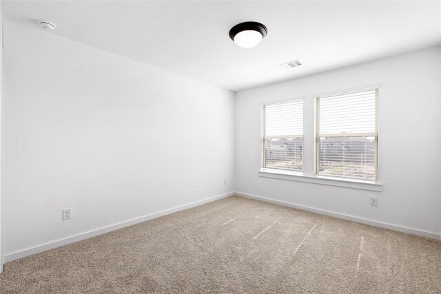 404 Kendall Crest Dr, Alvin, TX 77511 - spare room featuring light carpet, baseboards, and a smoke detector