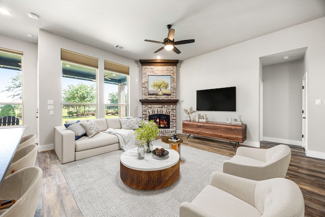 7114 Clubtail Rd, Katy, TX 77493 - living room featuring a ceiling fan, wood finished floors, baseboards, and a brick fireplace
