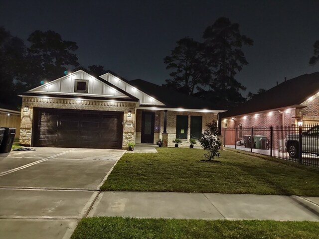 2716 Garapan St, Houston, TX 77091 - view of front facade with concrete driveway, an attached garage, board and batten siding, and brick siding