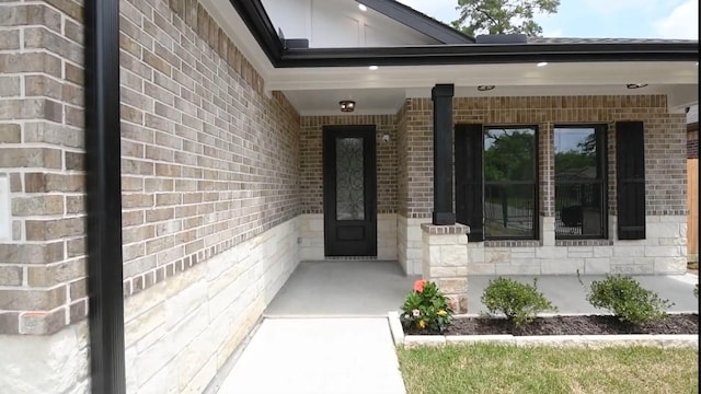 2716 Garapan St, Houston, TX 77091 - doorway to property with brick siding and covered porch